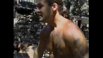 Tattooed muscle dude licks hairy pussy of a busty whore and fucks her doggy style in nature