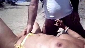 My horny wife playing with stranger at nude beach.