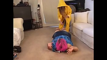 Slender chick in a yellow cloak fucks her chubby girlfriend with a big dildo